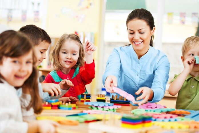 Nursery teacher playing with the kids.